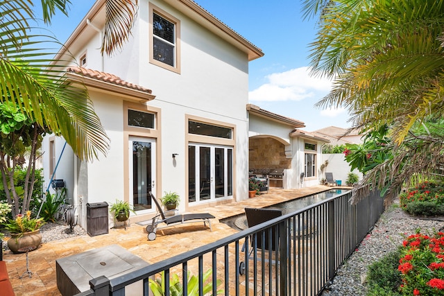 back of property with french doors and a patio