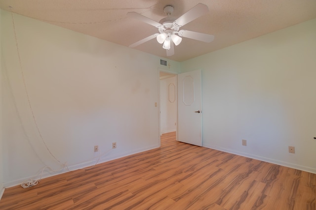 empty room featuring ceiling fan and light hardwood / wood-style floors