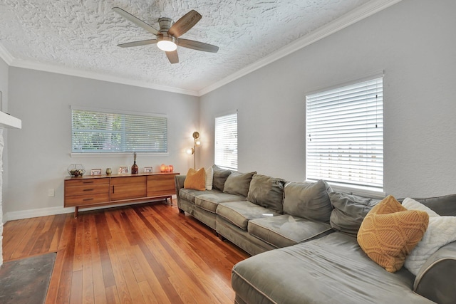 living room with ceiling fan, a textured ceiling, ornamental molding, and hardwood / wood-style flooring