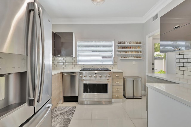 kitchen featuring light tile patterned floors, appliances with stainless steel finishes, crown molding, and backsplash