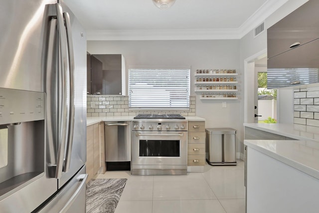 kitchen featuring crown molding, stainless steel appliances, light tile patterned floors, and backsplash