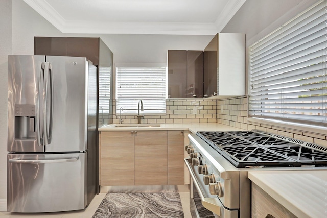 kitchen with sink, tasteful backsplash, ornamental molding, appliances with stainless steel finishes, and a healthy amount of sunlight