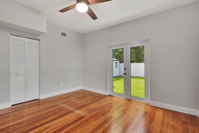 interior space with french doors, wood-type flooring, access to outside, ceiling fan, and a closet