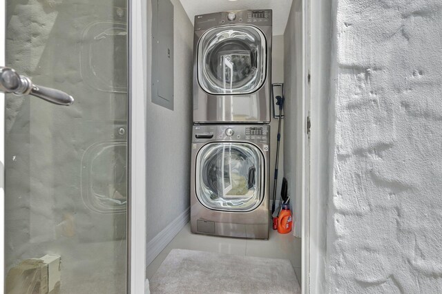 clothes washing area with stacked washer and clothes dryer