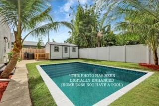 view of swimming pool featuring a storage shed