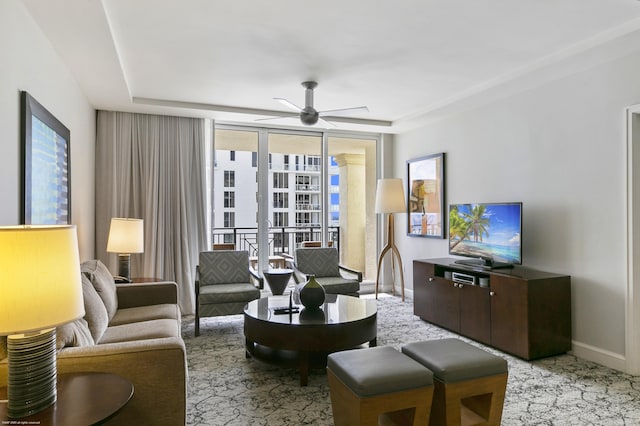 living room with expansive windows and ceiling fan