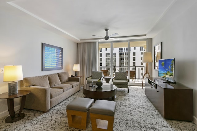 living room featuring expansive windows and ceiling fan