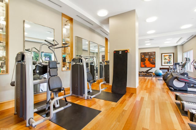 exercise room with hardwood / wood-style floors