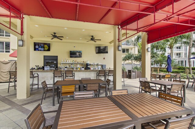 view of patio with a bar and ceiling fan