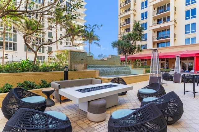 view of community with a patio area and an outdoor fire pit