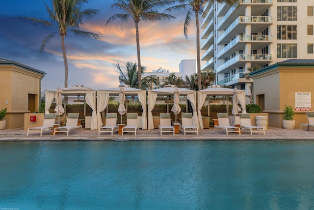 pool at dusk with a gazebo