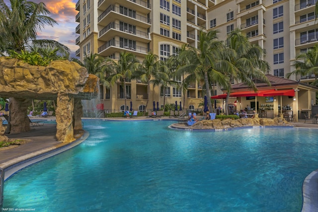 pool at dusk with pool water feature