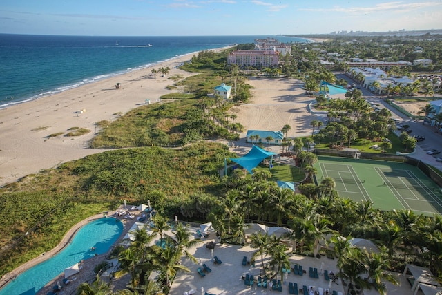 birds eye view of property with a water view and a view of the beach