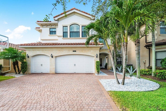 mediterranean / spanish-style house featuring a garage