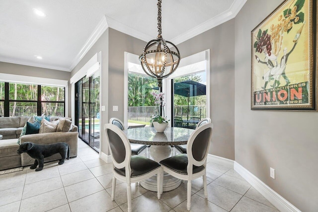 dining area with an inviting chandelier, light tile patterned floors, and crown molding