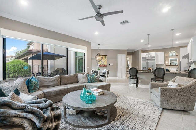 tiled living room with ceiling fan and crown molding