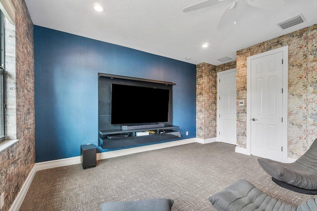 unfurnished living room with carpet flooring, a textured ceiling, and ceiling fan