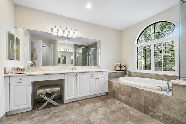 bathroom featuring independent shower and bath, vanity, and tile patterned flooring