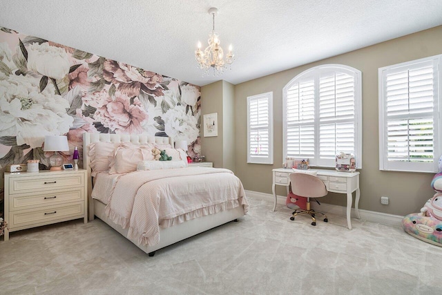 carpeted bedroom featuring a chandelier and a textured ceiling