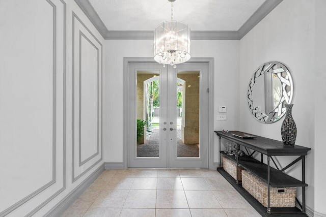 tiled foyer with crown molding, french doors, a notable chandelier, and a textured ceiling