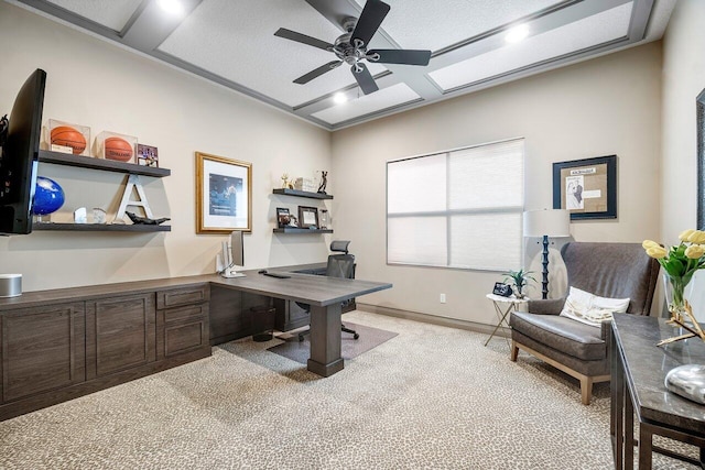 office area featuring a textured ceiling, ceiling fan, and light colored carpet