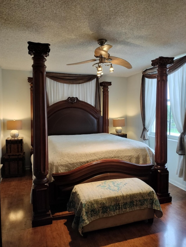 bedroom with ceiling fan, wood-type flooring, a textured ceiling, and ornate columns