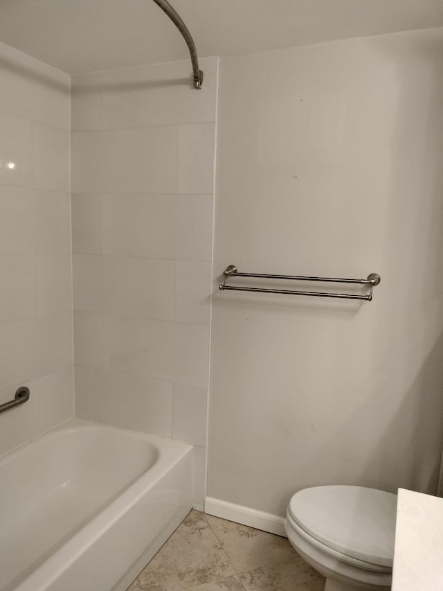 bathroom featuring washtub / shower combination, tile patterned floors, and toilet