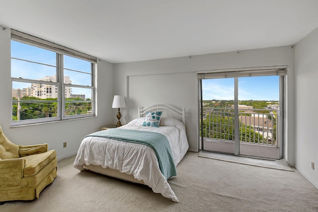 bedroom with light carpet and access to exterior