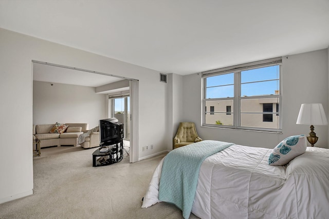 carpeted bedroom featuring multiple windows