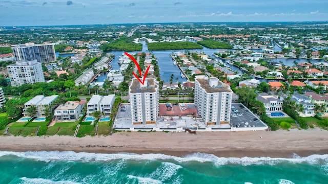 birds eye view of property featuring a water view and a view of the beach