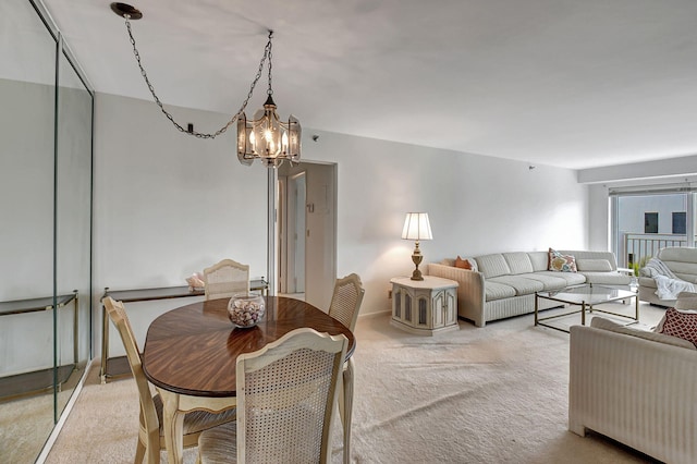 carpeted living room featuring a chandelier