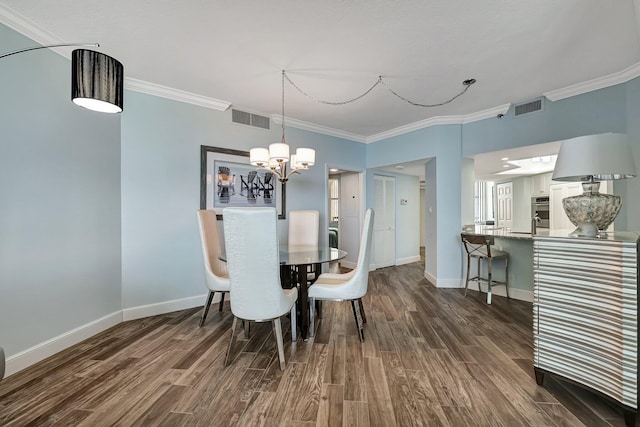 dining space featuring dark wood-type flooring, ornamental molding, and a notable chandelier