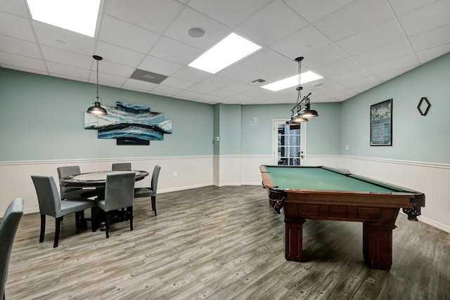 game room with a paneled ceiling and hardwood / wood-style floors