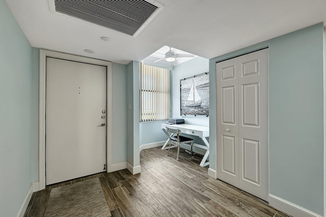 entryway with wood-type flooring and ceiling fan