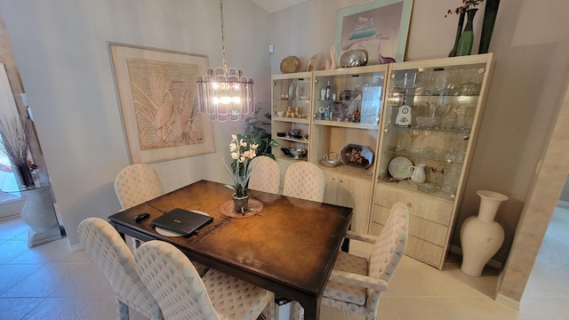 tiled dining room featuring a notable chandelier