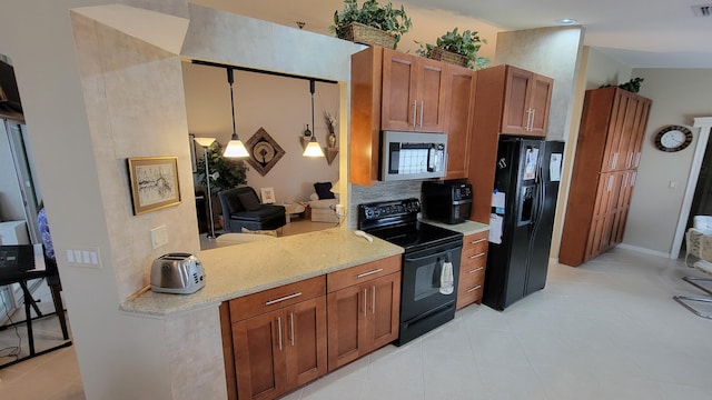 kitchen featuring light tile patterned floors, kitchen peninsula, light stone counters, black appliances, and pendant lighting