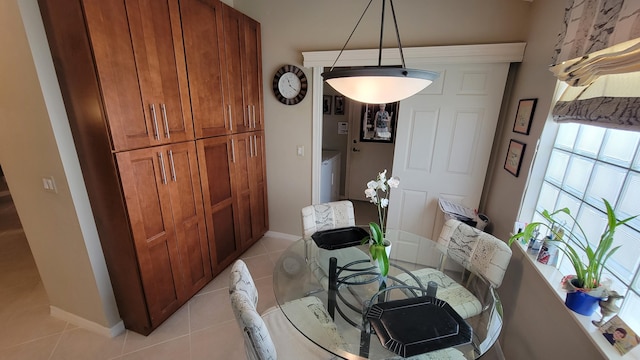 tiled dining area with washer / clothes dryer