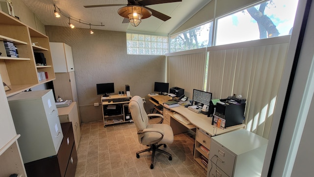 tiled office space with ceiling fan, vaulted ceiling, and track lighting