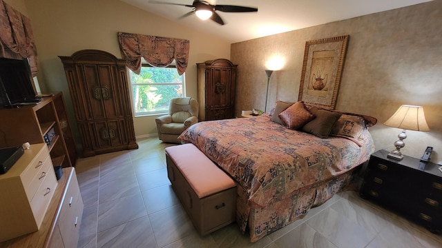 tiled bedroom featuring ceiling fan and vaulted ceiling