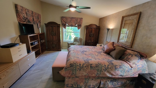 bedroom with lofted ceiling, light tile patterned floors, and ceiling fan