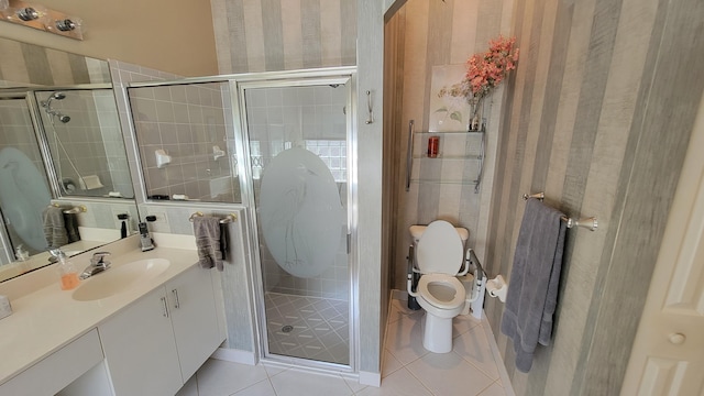 bathroom with vanity, tile patterned floors, a shower with door, and toilet