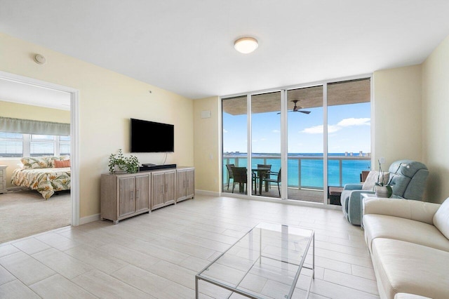 living room featuring expansive windows and ceiling fan