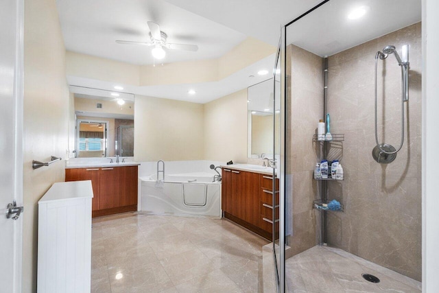 bathroom featuring ceiling fan, independent shower and bath, and vanity