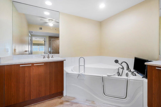 bathroom featuring a washtub, ceiling fan, and vanity