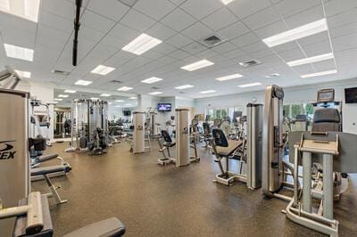 gym with a paneled ceiling