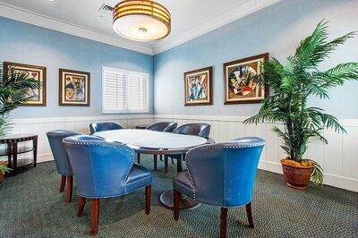 dining space featuring ornamental molding and dark colored carpet