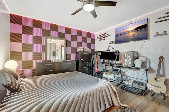 bedroom with ceiling fan and hardwood / wood-style floors