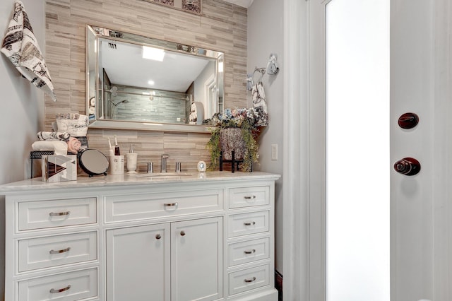 bathroom featuring vanity, decorative backsplash, and tile walls