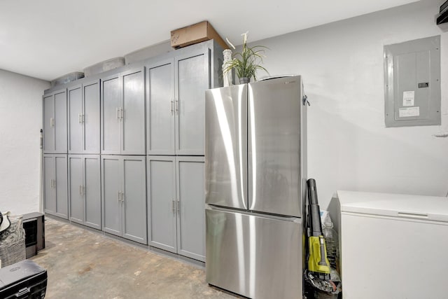 kitchen with stainless steel refrigerator, gray cabinetry, and electric panel