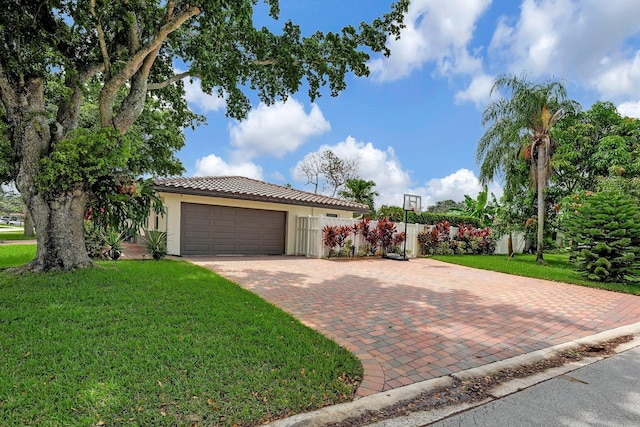 view of front of home featuring a garage and a front lawn